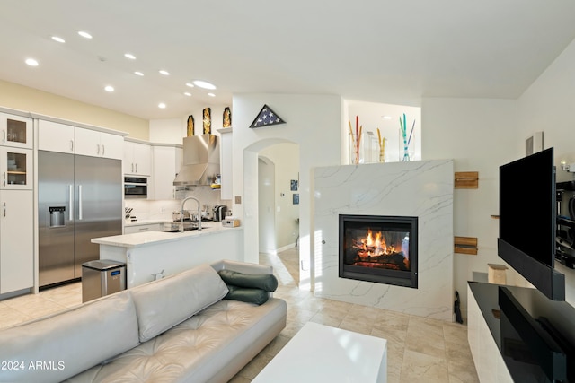 living room with a fireplace and sink