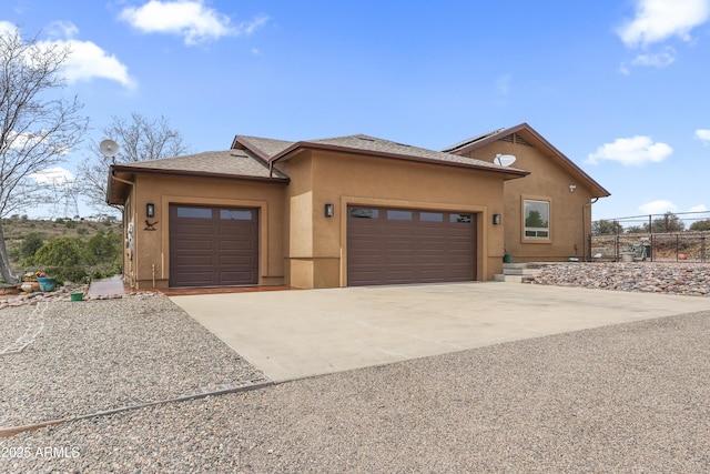 11880 N Cielo Grande, Prescott, AZ 86305 - view of front facade with a shingled roof, a garage, fence, stucco siding, and driveway