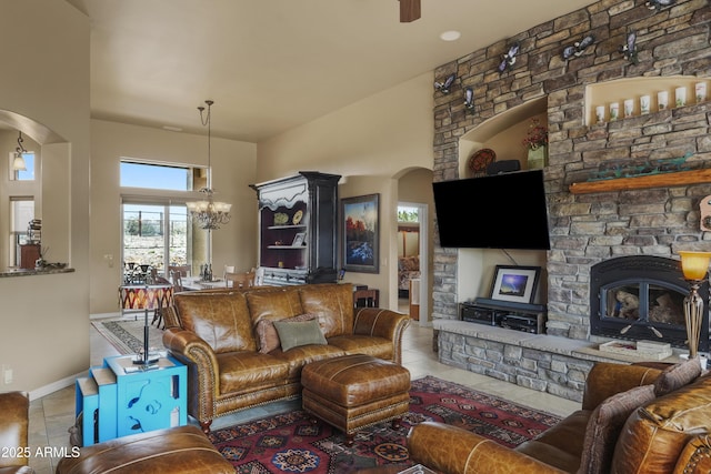 11880 N Cielo Grande, Prescott, AZ 86305 - tiled living area featuring baseboards, a notable chandelier, and a stone fireplace
