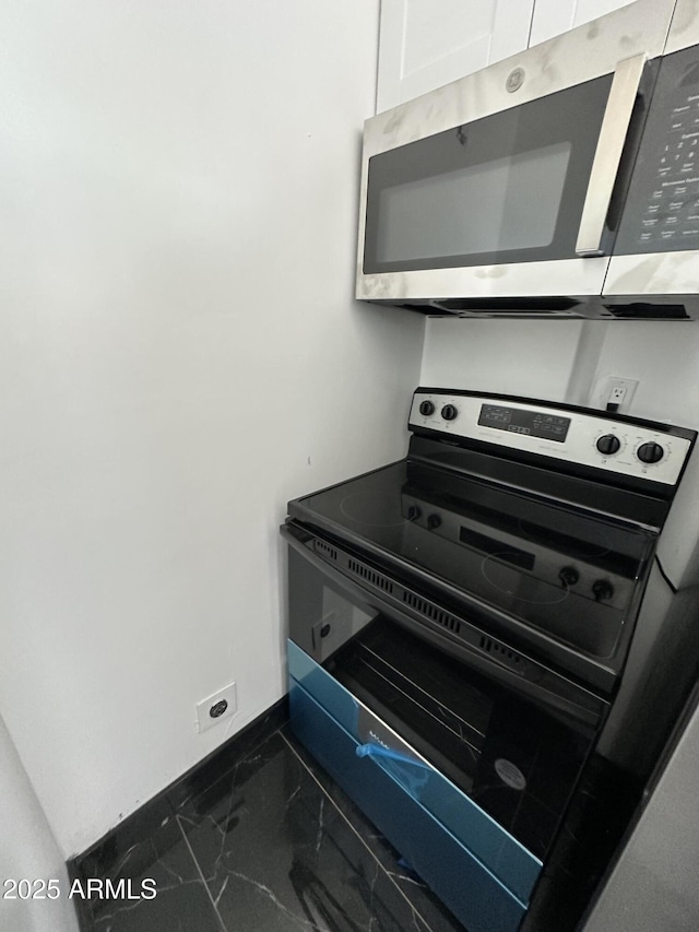 room details with stainless steel appliances and baseboards