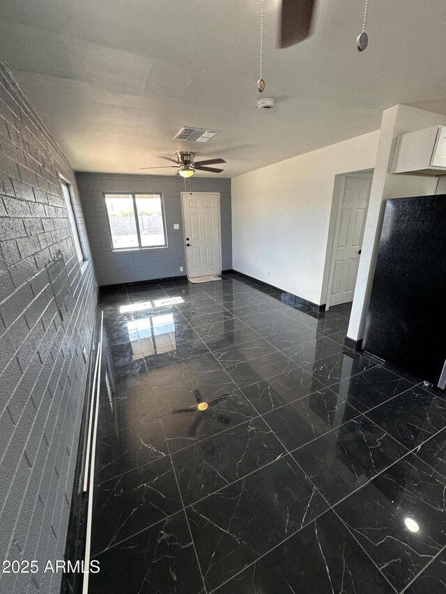 unfurnished living room with marble finish floor, ceiling fan, baseboards, and visible vents