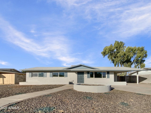 ranch-style home featuring a carport