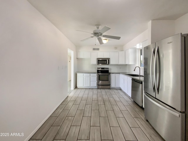 kitchen with white cabinetry, sink, ceiling fan, and stainless steel appliances