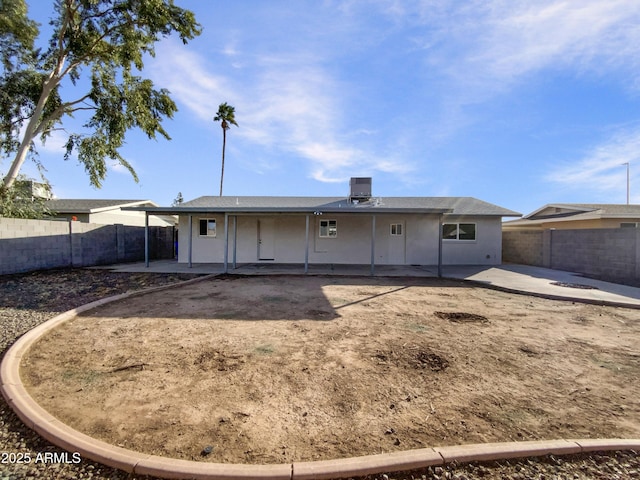 rear view of house featuring central AC unit and a patio area