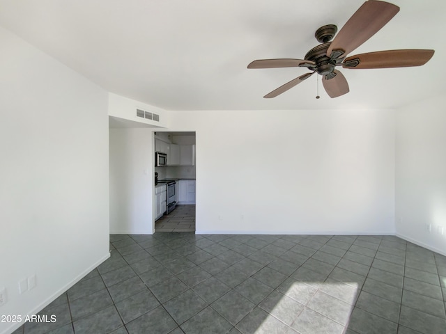 empty room featuring tile patterned floors and ceiling fan