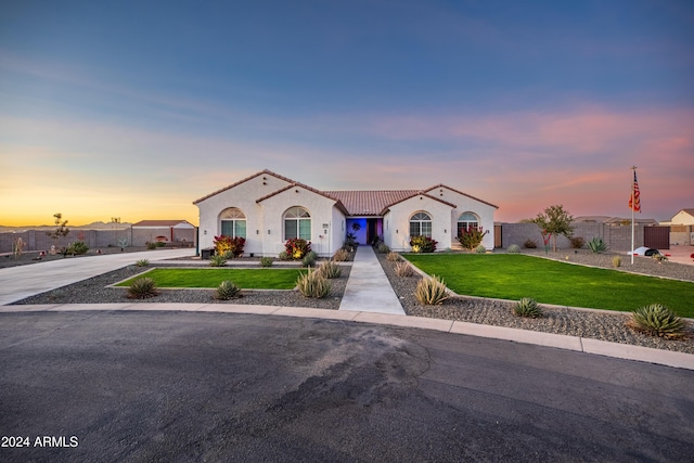 mediterranean / spanish-style house with a yard