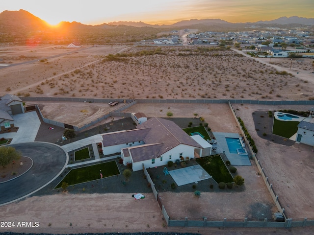 aerial view at dusk featuring a mountain view