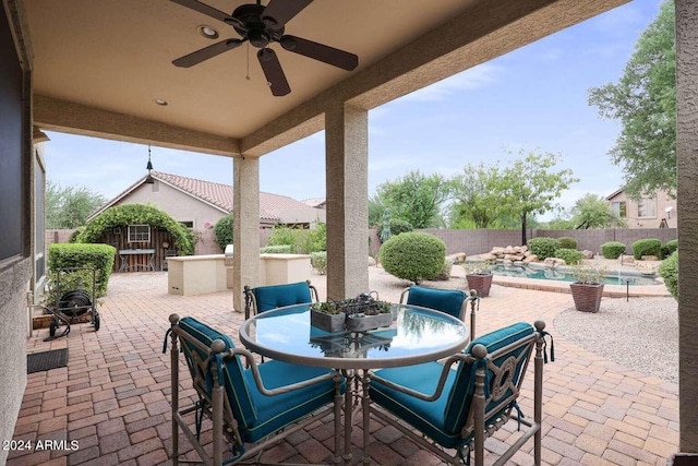 view of patio featuring a fenced in pool and ceiling fan