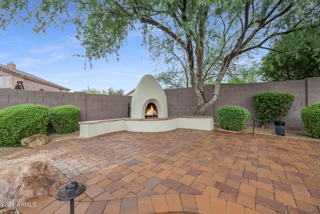 view of patio / terrace with an outdoor fireplace