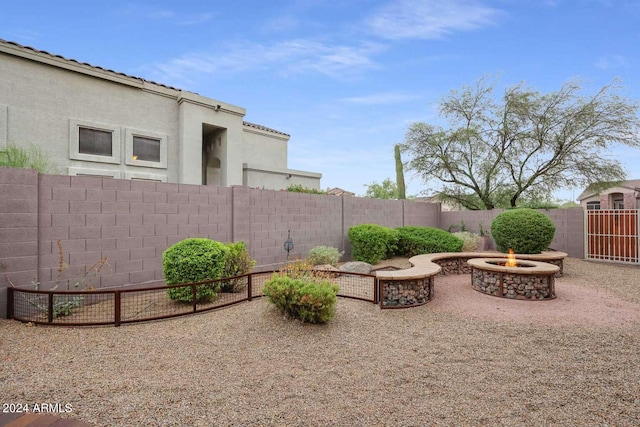 view of yard with a patio and an outdoor fire pit