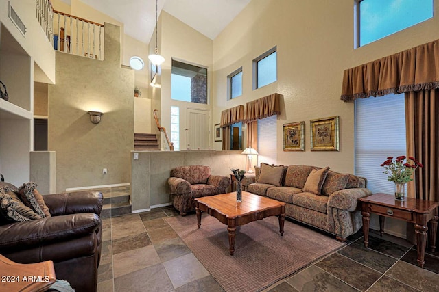 living room featuring high vaulted ceiling