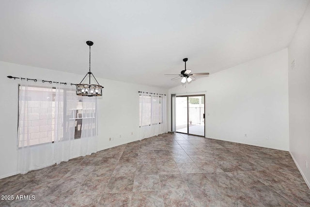 spare room with a chandelier, a ceiling fan, lofted ceiling, and baseboards