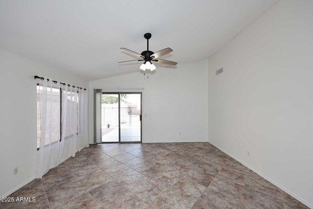 spare room featuring lofted ceiling, ceiling fan, and baseboards