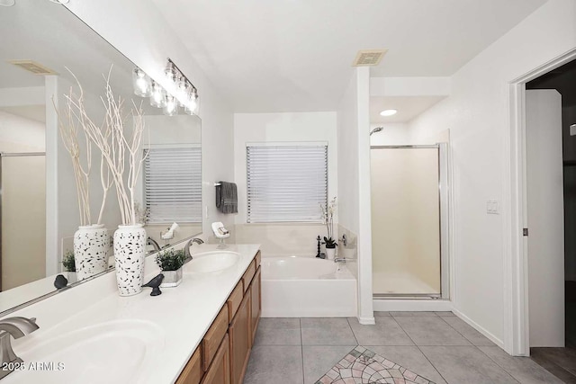 full bath with a garden tub, a shower stall, tile patterned flooring, and double vanity
