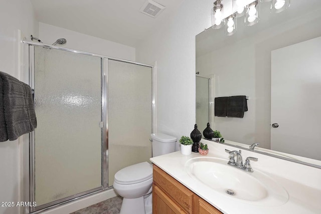bathroom with toilet, a stall shower, and vanity