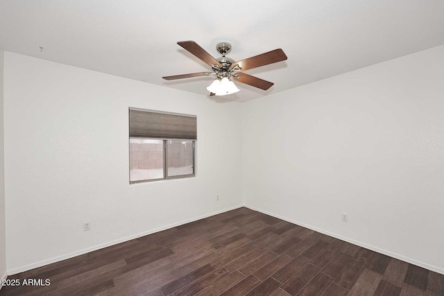 unfurnished room featuring dark wood finished floors, ceiling fan, and baseboards