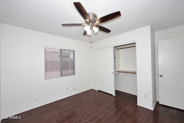 unfurnished bedroom featuring wood finished floors, baseboards, a closet, and ceiling fan