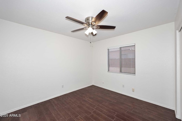 unfurnished room featuring a ceiling fan, wood finished floors, and baseboards
