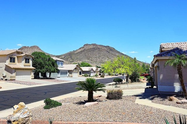 view of asphalt road with a mountain view and a residential view