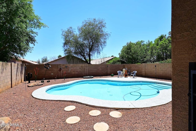 view of pool with a fenced backyard