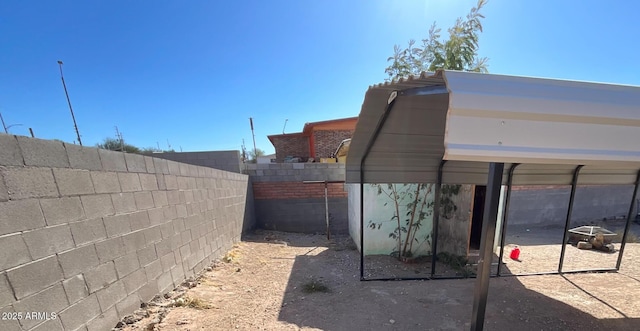 view of home's exterior featuring a fenced backyard and a detached carport