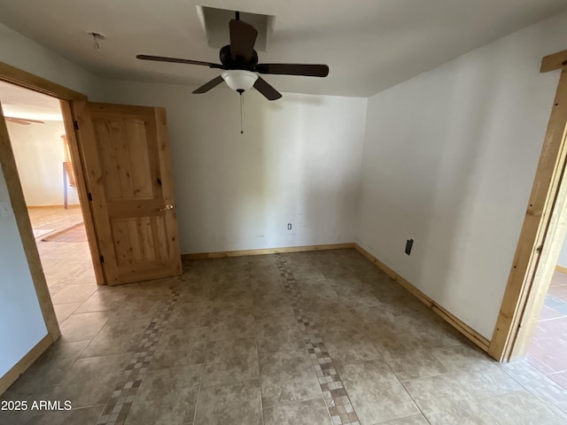 empty room with baseboards and a ceiling fan