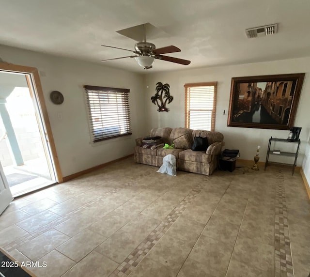 living area featuring visible vents, light tile patterned floors, and plenty of natural light