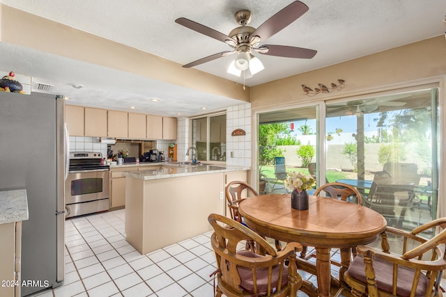 tiled dining area featuring a textured ceiling and ceiling fan