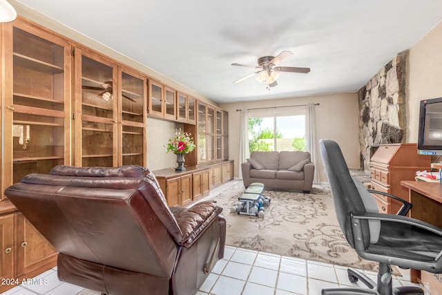 home office with light tile patterned floors and ceiling fan