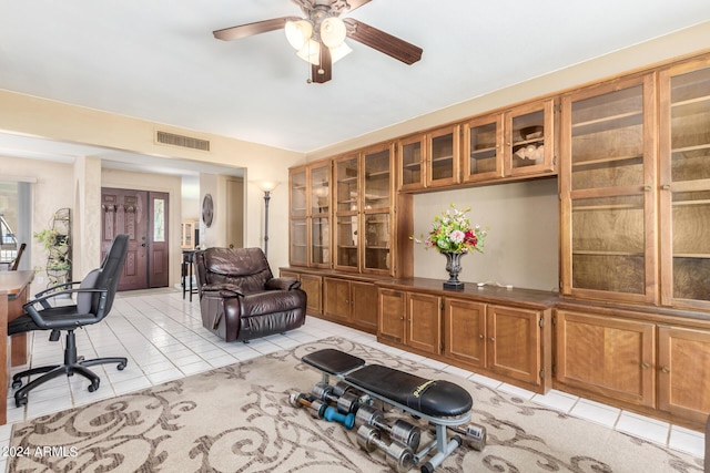 interior space with light tile patterned floors, visible vents, and a ceiling fan