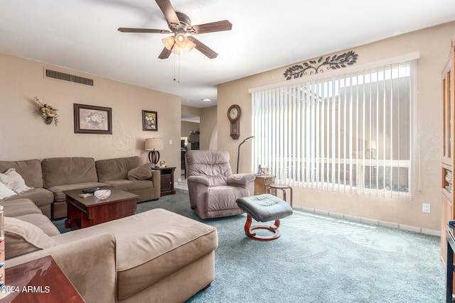 carpeted living room with baseboards, visible vents, and a ceiling fan