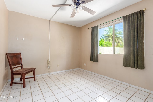 tiled empty room featuring ceiling fan