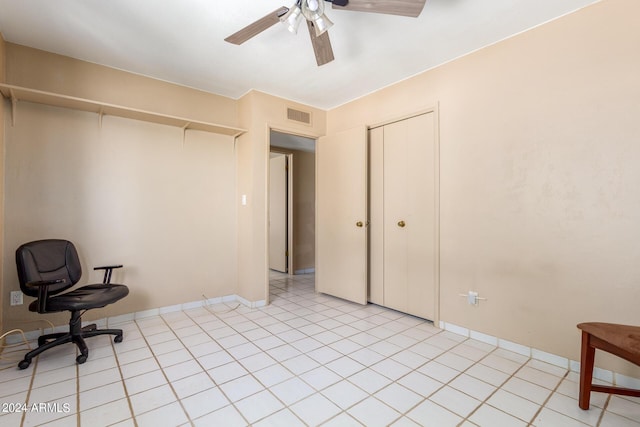 office area with visible vents, ceiling fan, baseboards, and light tile patterned floors