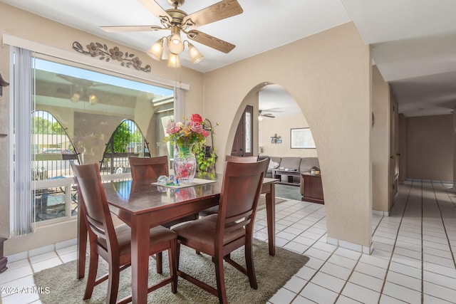 dining area with ceiling fan and light tile patterned flooring