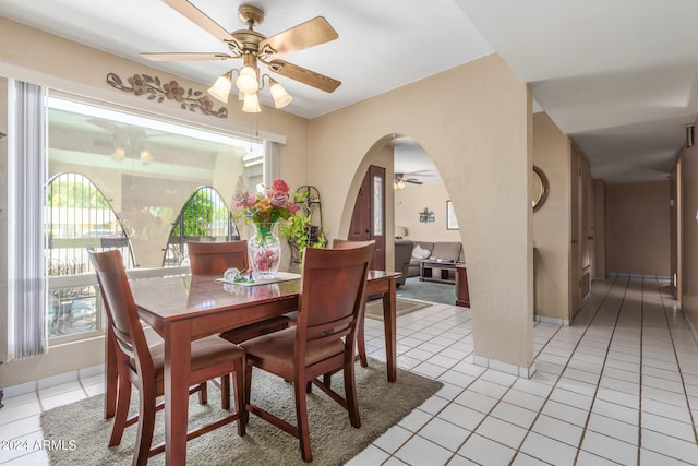 dining space featuring ceiling fan, light tile patterned flooring, and plenty of natural light