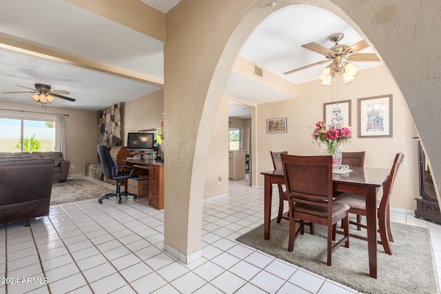 tiled dining space with ceiling fan