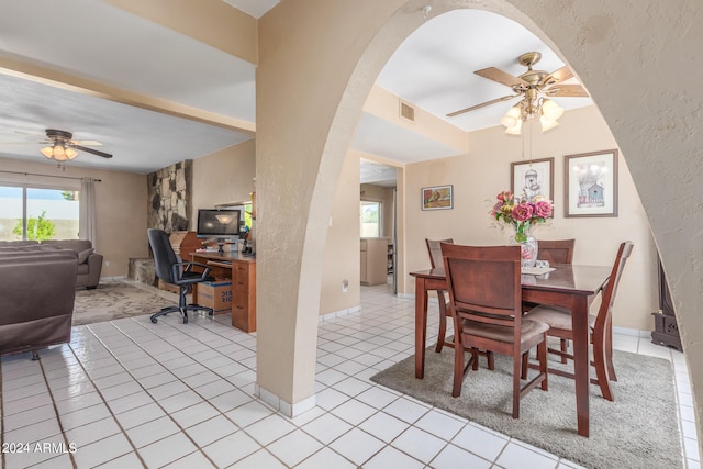 tiled dining space featuring ceiling fan