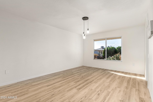 spare room featuring light hardwood / wood-style flooring