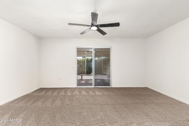 carpeted spare room with ceiling fan