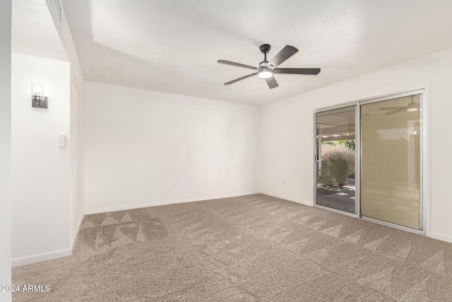 carpeted empty room featuring ceiling fan