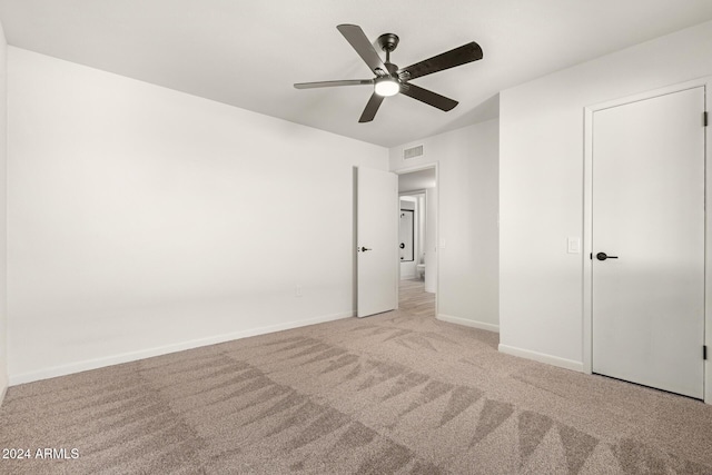 unfurnished bedroom with ceiling fan and light carpet