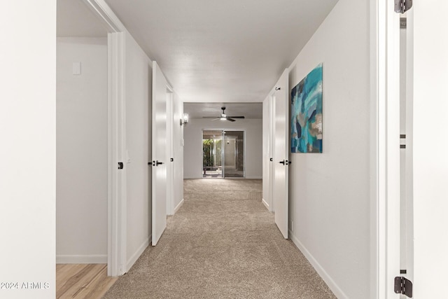 corridor with light colored carpet