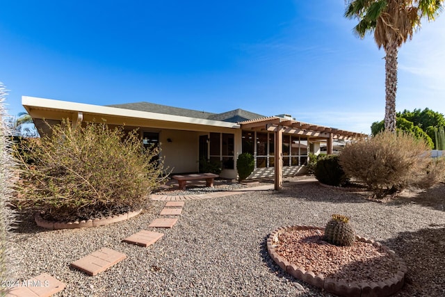 rear view of property with a pergola and a patio