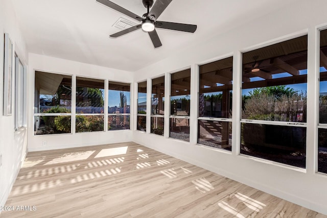 unfurnished sunroom featuring ceiling fan