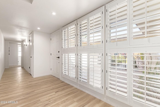 hall with light hardwood / wood-style flooring