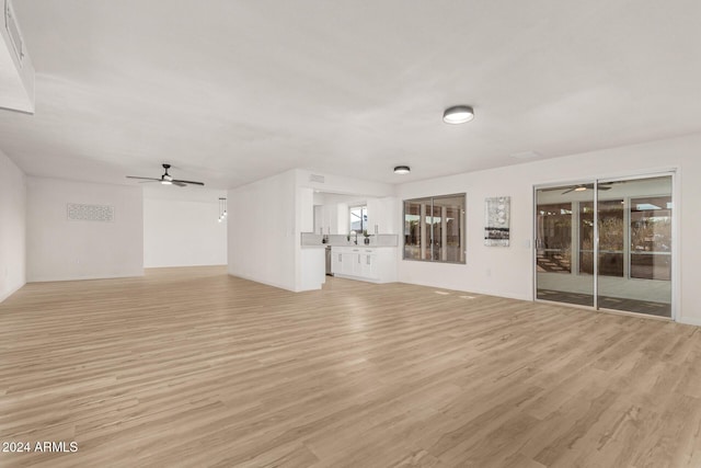 unfurnished living room featuring light wood-type flooring and ceiling fan