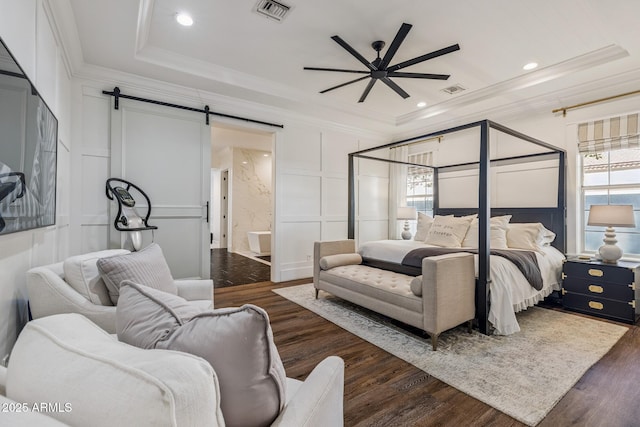 2625 N 24th St Unit 15, Mesa, AZ 85213 - bedroom with a decorative wall, a barn door, ornamental molding, dark wood-style floors, and a tray ceiling
