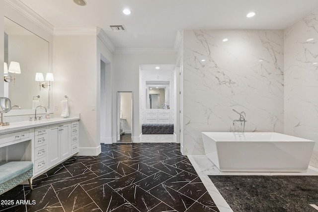 2625 N 24th St Unit 15, Mesa, AZ 85213 - bathroom featuring ornamental molding, marble tiled flooring, a freestanding tub, stone wall, and vanity