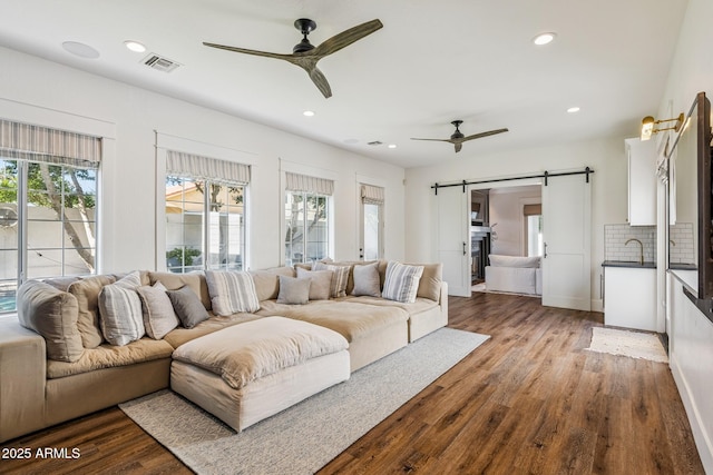 2625 N 24th St Unit 15, Mesa, AZ 85213 - living area with a barn door, ceiling fan, wood finished floors, and recessed lighting