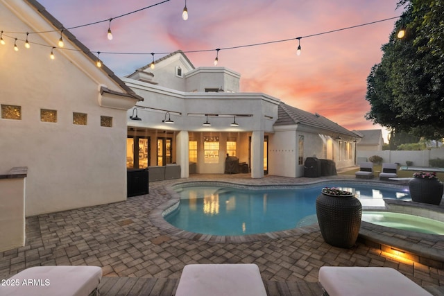 2625 N 24th St Unit 15, Mesa, AZ 85213 - pool at dusk featuring a patio and a pool with connected hot tub